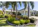 Charming home with a lush landscaped front yard and well-maintained exterior featuring an attached three car garage at 581 Mast Dr, Bradenton, FL 34208