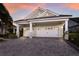 Attached three-car garage with white doors, and a well-manicured lawn adds curb appeal to the home's exterior at 581 Mast Dr, Bradenton, FL 34208