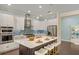 A kitchen featuring white cabinetry, stainless steel appliances, and a center island with seating at 581 Mast Dr, Bradenton, FL 34208