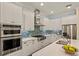 Bright kitchen featuring white cabinets, stainless steel appliances, and modern countertops at 581 Mast Dr, Bradenton, FL 34208