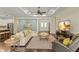 Spacious living room featuring dark wood floors, recessed lighting, and an entertainment center at 581 Mast Dr, Bradenton, FL 34208