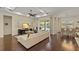 Open concept living room features modern kitchen, dining room, and sliding doors to the outdoor patio and pool at 581 Mast Dr, Bradenton, FL 34208