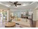 Open concept living room leading to a modern kitchen with center island and breakfast bar; views of outdoor pool at 581 Mast Dr, Bradenton, FL 34208