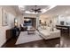 Open-concept living room with hardwood floors, ceiling fan, and sliding glass doors that lead to the backyard pool area at 581 Mast Dr, Bradenton, FL 34208