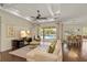 Elegant living room with a coffered ceiling, large windows, and seamless access to the outdoor pool area at 581 Mast Dr, Bradenton, FL 34208