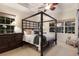 The main bedroom boasts a four poster bed, comfortable lighting and neutral colors at 581 Mast Dr, Bradenton, FL 34208