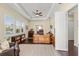 Office space with a wooden desk, tray ceiling, and large window at 581 Mast Dr, Bradenton, FL 34208