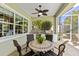 Covered patio featuring an outdoor kitchen with a built-in grill, sink, and mini-fridge, ideal for entertaining guests at 581 Mast Dr, Bradenton, FL 34208