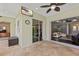 Inviting outdoor patio with tile flooring, fan, and access to the living room, perfect for relaxing and entertaining at 581 Mast Dr, Bradenton, FL 34208