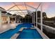 This screened-in pool area features an in-ground spa and swim up bar for your enjoyment! at 581 Mast Dr, Bradenton, FL 34208