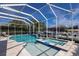 Beautiful pool and spa surrounded by travertine tile, creating a luxurious outdoor oasis at 581 Mast Dr, Bradenton, FL 34208