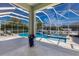Covered pool area with travertine tile and beautiful design, perfect for outdoor entertaining and relaxation at 581 Mast Dr, Bradenton, FL 34208