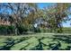 A tennis court offers opportunities for recreation amidst mature trees and lush greenery at 581 Mast Dr, Bradenton, FL 34208