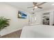 Spacious bedroom featuring a ceiling fan, TV, and ample closet space for storage at 600 Manatee Ave # 114, Holmes Beach, FL 34217