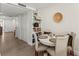 Dining area with table, four chairs, and hallway access to other parts of the home at 600 Manatee Ave # 114, Holmes Beach, FL 34217