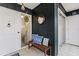 Stylish entryway with dark wood paneling, a wooden bench with blue pillows, and decorative accents at 600 Manatee Ave # 114, Holmes Beach, FL 34217