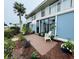 Beautiful exterior view of a two-story building featuring white balconies and meticulously maintained landscaping at 600 Manatee Ave # 114, Holmes Beach, FL 34217