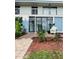 Beautiful exterior view of a two-story building featuring white balconies and meticulously maintained landscaping at 600 Manatee Ave # 114, Holmes Beach, FL 34217