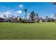 Expansive front lawn with lush greenery and well-maintained landscaping at 600 Manatee Ave # 114, Holmes Beach, FL 34217