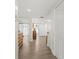 Hallway with wood-look floors and bright lighting leading to the main areas of the home at 600 Manatee Ave # 114, Holmes Beach, FL 34217