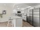 Well-lit kitchen with stainless steel appliances, white cabinetry, and stylish countertops at 600 Manatee Ave # 114, Holmes Beach, FL 34217