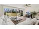 Cozy living room with sliding glass doors offering views of the landscaped outdoor area at 600 Manatee Ave # 114, Holmes Beach, FL 34217