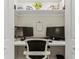 Efficient home office nook featuring a built-in desk and shelving for organization at 600 Manatee Ave # 114, Holmes Beach, FL 34217