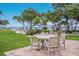Charming outdoor patio featuring a table and chairs with scenic ocean views at 600 Manatee Ave # 114, Holmes Beach, FL 34217