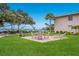 Lovely backyard with seating area and manicured lawn overlooking the water at 600 Manatee Ave # 114, Holmes Beach, FL 34217