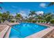 Inviting swimming pool surrounded by lush landscaping and comfortable lounge chairs at 600 Manatee Ave # 114, Holmes Beach, FL 34217