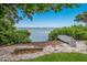 Beautiful waterfront view with clear blue skies, calm waters, and lush greenery, creating a serene and peaceful setting at 600 Manatee Ave # 114, Holmes Beach, FL 34217