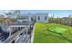 Beautiful backyard with green lawn, putting green, outdoor kitchen, and rooftop deck for entertaining at 603 Tremont St, Sarasota, FL 34242
