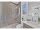 Bathroom featuring a glass-enclosed shower, modern fixtures, and stylish tiling and finishes at 603 Tremont St, Sarasota, FL 34242