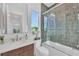 Bathroom showcasing a glass-enclosed shower-tub, modern vanity, and stylish fixtures at 603 Tremont St, Sarasota, FL 34242