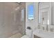 Modern bathroom featuring tiled shower, contemporary vanity, and bright natural light at 603 Tremont St, Sarasota, FL 34242