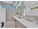 Bright bathroom features double sink vanity, soaking tub, walk-in shower and window that brings in natural light at 603 Tremont St, Sarasota, FL 34242