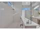 Glass enclosed shower featuring white tile surround and dual shower heads at 603 Tremont St, Sarasota, FL 34242