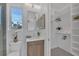 This contemporary bathroom offers a tiled shower, a vanity, and an organized closet at 603 Tremont St, Sarasota, FL 34242