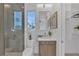 Modern bathroom with a tiled shower, walk-in closet, and stylish vanity at 603 Tremont St, Sarasota, FL 34242