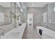 Bright bathroom features double sink vanity, soaking tub, walk-in shower and window that brings in natural light at 603 Tremont St, Sarasota, FL 34242