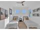 Bright bedroom featuring twin beds, modern décor, and a ceiling fan at 603 Tremont St, Sarasota, FL 34242