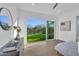 Bedroom featuring wood floors and backyard views through a large glass door at 603 Tremont St, Sarasota, FL 34242