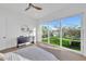 Bedroom with wood floors and a backyard view through a large glass door at 603 Tremont St, Sarasota, FL 34242
