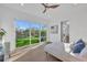 Bright bedroom with ensuite bathroom, wood floors, and a large glass door to the backyard at 603 Tremont St, Sarasota, FL 34242