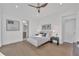 Airy bedroom features light wood floors, a ceiling fan, and an ensuite bathroom at 603 Tremont St, Sarasota, FL 34242