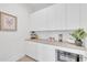 A well-organized butler pantry with white cabinets, countertops, and modern appliances at 603 Tremont St, Sarasota, FL 34242