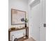 Entry hall with a modern console table and white walls, leading to a closed door at 603 Tremont St, Sarasota, FL 34242