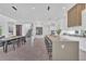 Bright, open-concept kitchen and dining area with a large island, wine storage, and modern decor at 603 Tremont St, Sarasota, FL 34242