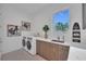 Well-lit laundry room boasts modern appliances, ample counter space, and stylish decor at 603 Tremont St, Sarasota, FL 34242
