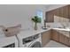 A laundry room features front load washer and dryer, modern cabinetry, and a bright window at 603 Tremont St, Sarasota, FL 34242